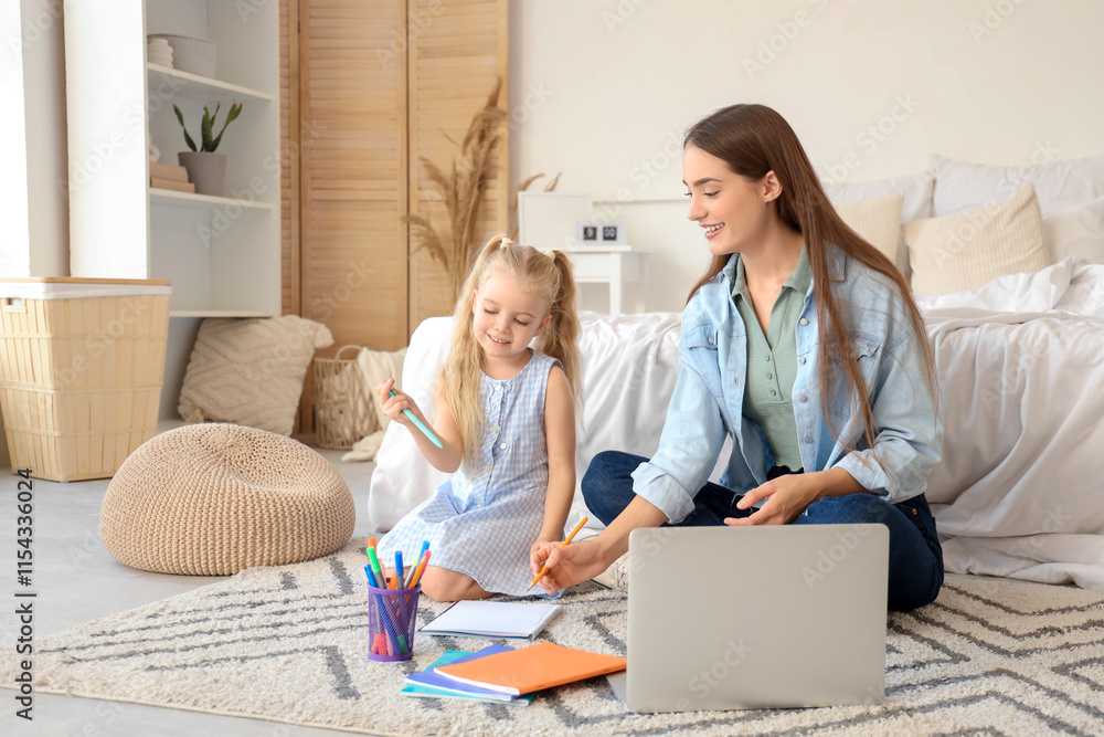 Fototapeta premium Nanny with cute little girl studying in bedroom