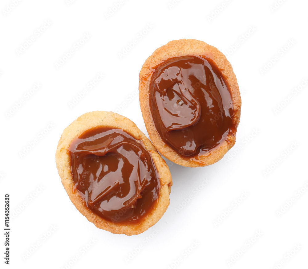 Halves of sweet walnut shaped cookie with boiled condensed milk on white background Halves of sweet walnut shaped cookie with boiled condensed milk on white background