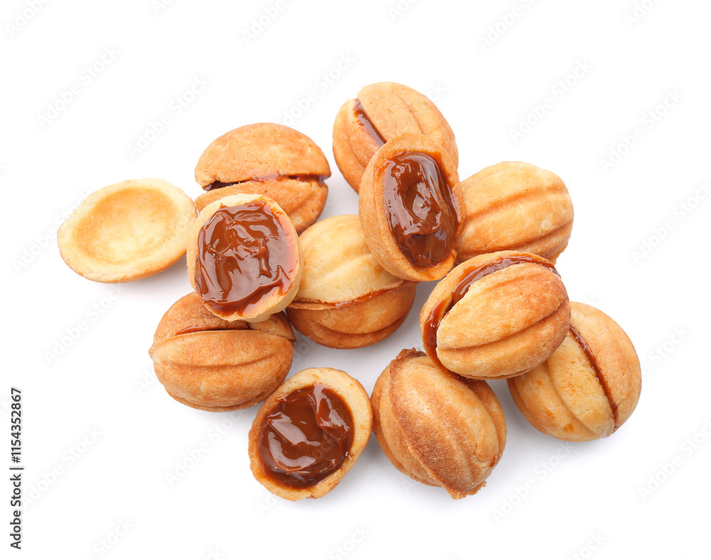 Many sweet walnut shaped cookies with boiled condensed milk on white background Many sweet walnut shaped cookies with boiled condensed milk on white background
