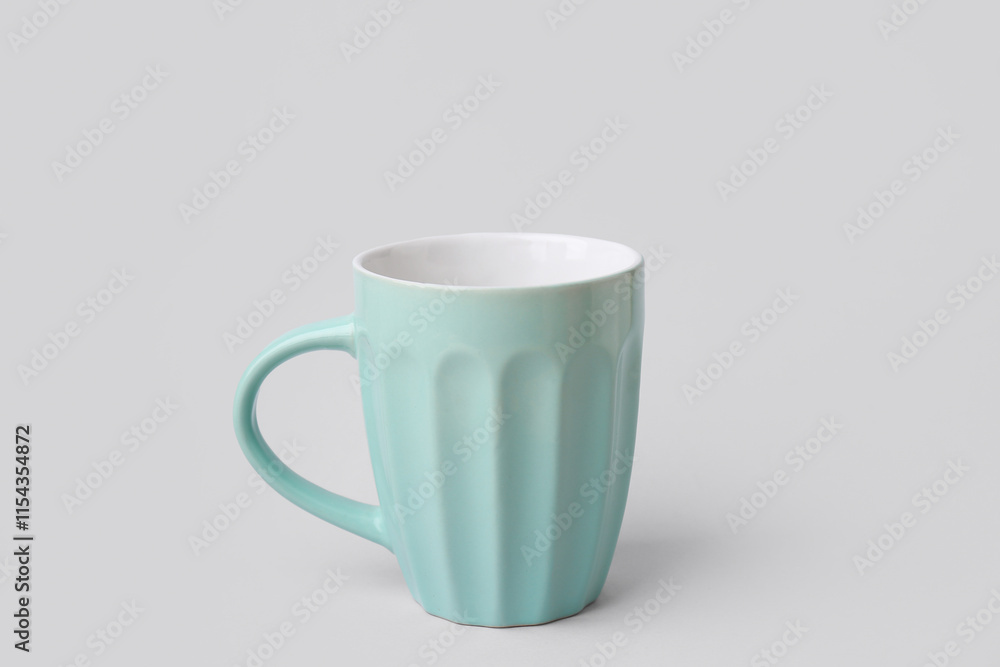 Obraz premium Blue ceramic cup on grey background