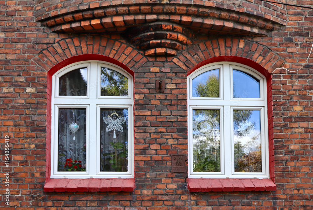 Close up view of windows of red brick old building in Nikiszowiec historic mining district of Katowice, Poland Close up view of windows of red brick old building in Nikiszowiec historic mining district of Katowice, Poland