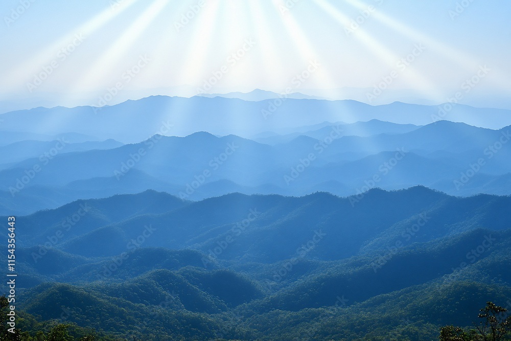 Obraz premium Serene mountain landscape with soft rays of light illuminating peaks.