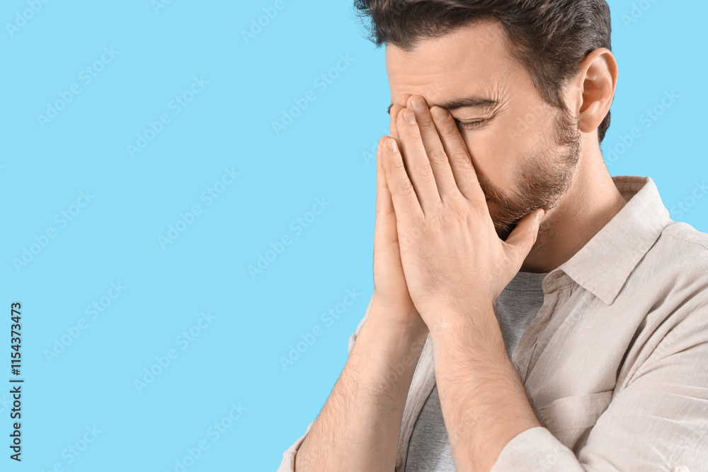 Portrait of worried man on blue background Portrait of worried man on blue background