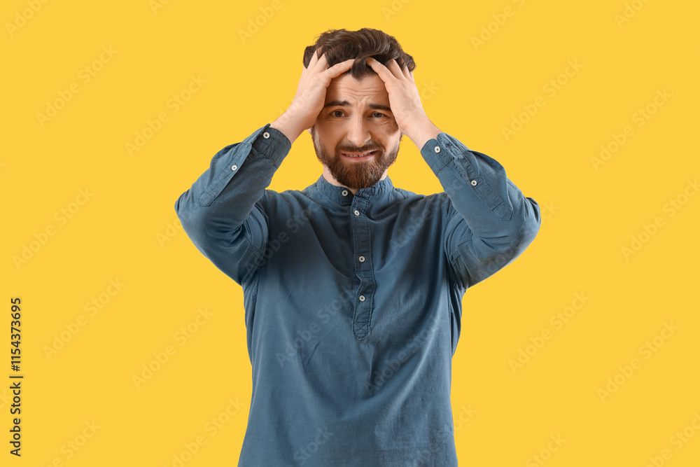 Portrait of worried man on yellow background Portrait of worried man on yellow background