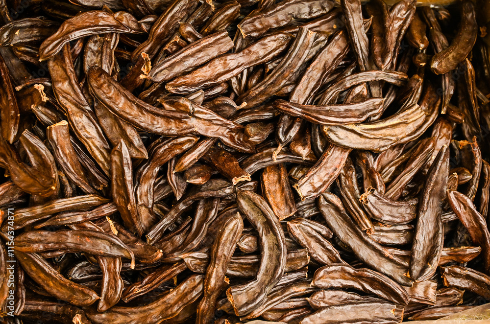 Ripe carob for sale at the market. Carob pods. Ripe carob for sale at the market. Carob pods.