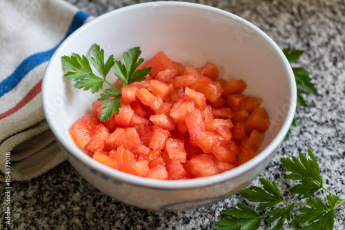 Bowl with tomato concasse. Tomato with no skin and no seeds. photo