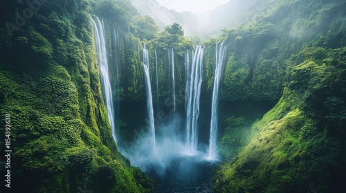 A breathtaking waterfall surrounded by lush greenery and misty atmosphere.