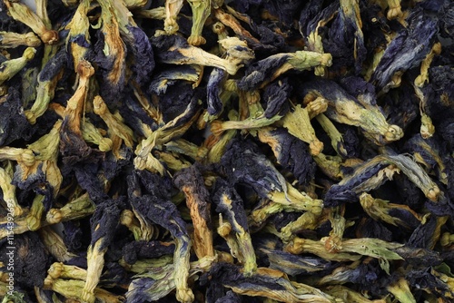 Butterfly pea flower tea. Dry Clitoria ternatea petals as background, top view photo