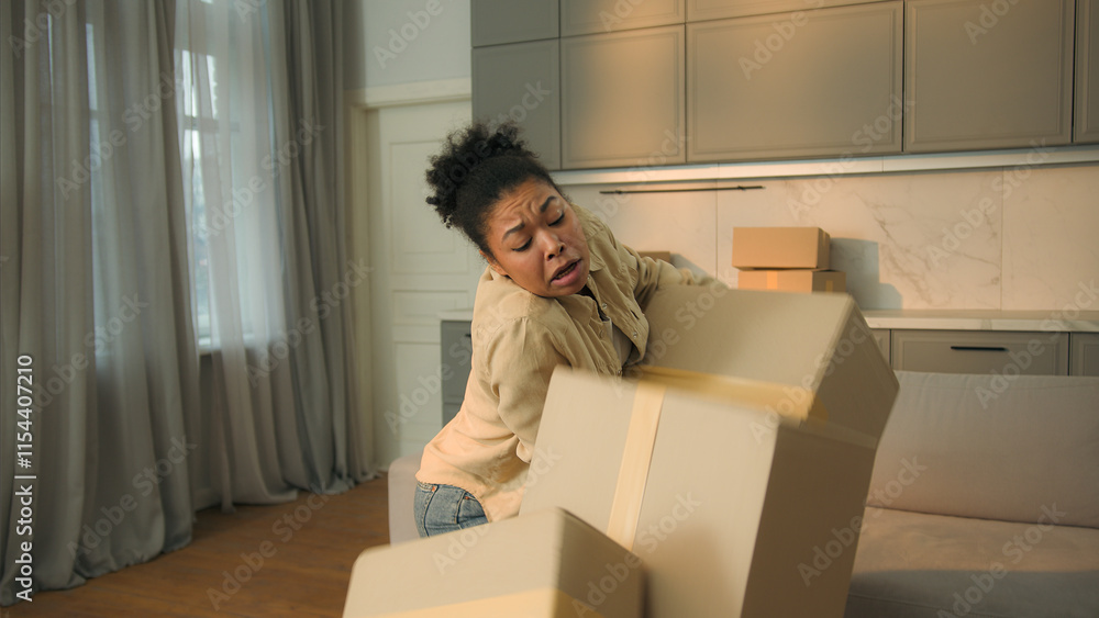 Female homeowner African American woman tenant moving in new home relocation carry cardboard deliver parcels tired courier drop boxes crash failure shopping delivery disappointed upset girl in kitchen Female homeowner African American woman tenant moving in new home relocation carry cardboard deliver parcels tired courier drop boxes crash failure shopping delivery disappointed upset girl in kitchen