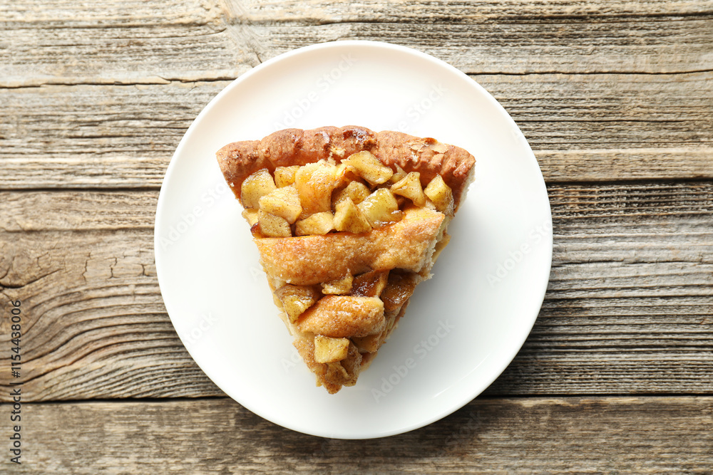 Slice of homemade apple pie on wooden table, top view Slice of homemade apple pie on wooden table, top view