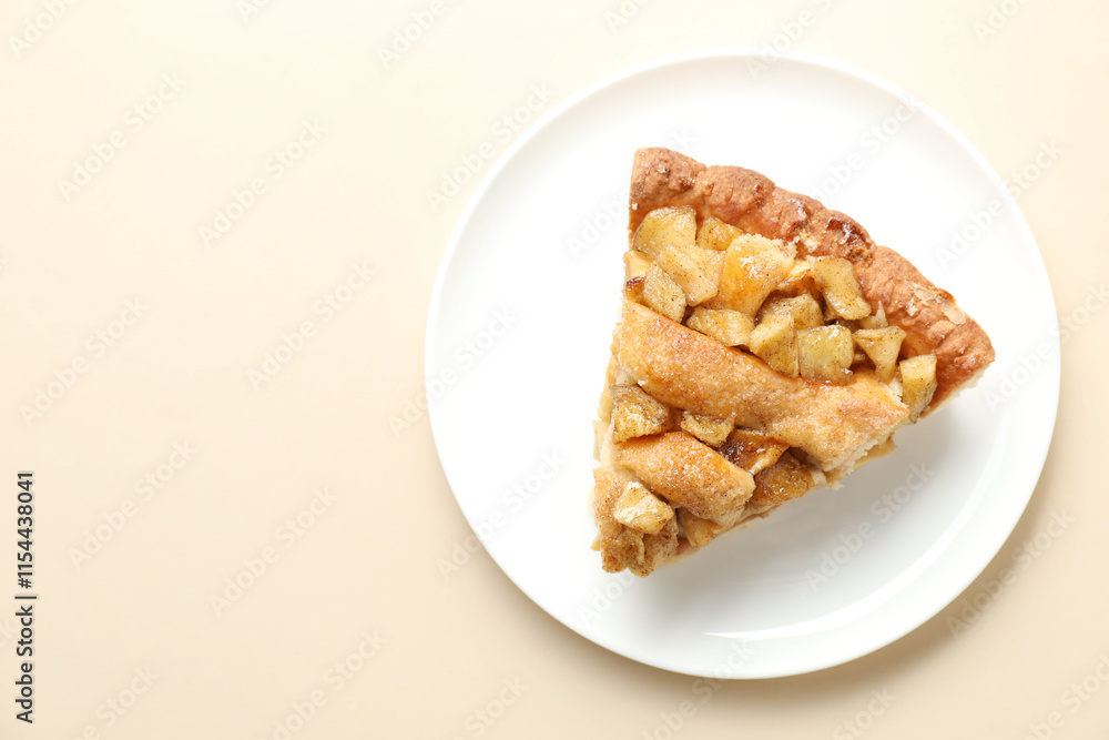 Slice of homemade apple pie on beige background, top view. Space for text Slice of homemade apple pie on beige background, top view. Space for text