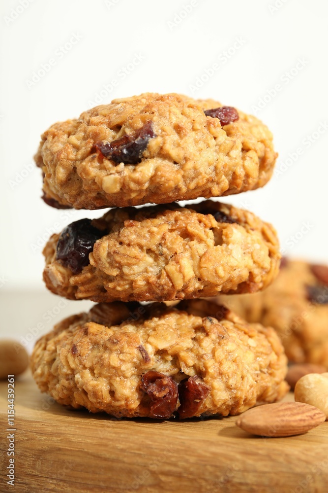 Delicious oatmeal cookies with raisins and nuts on table, closeup Delicious oatmeal cookies with raisins and nuts on table, closeup