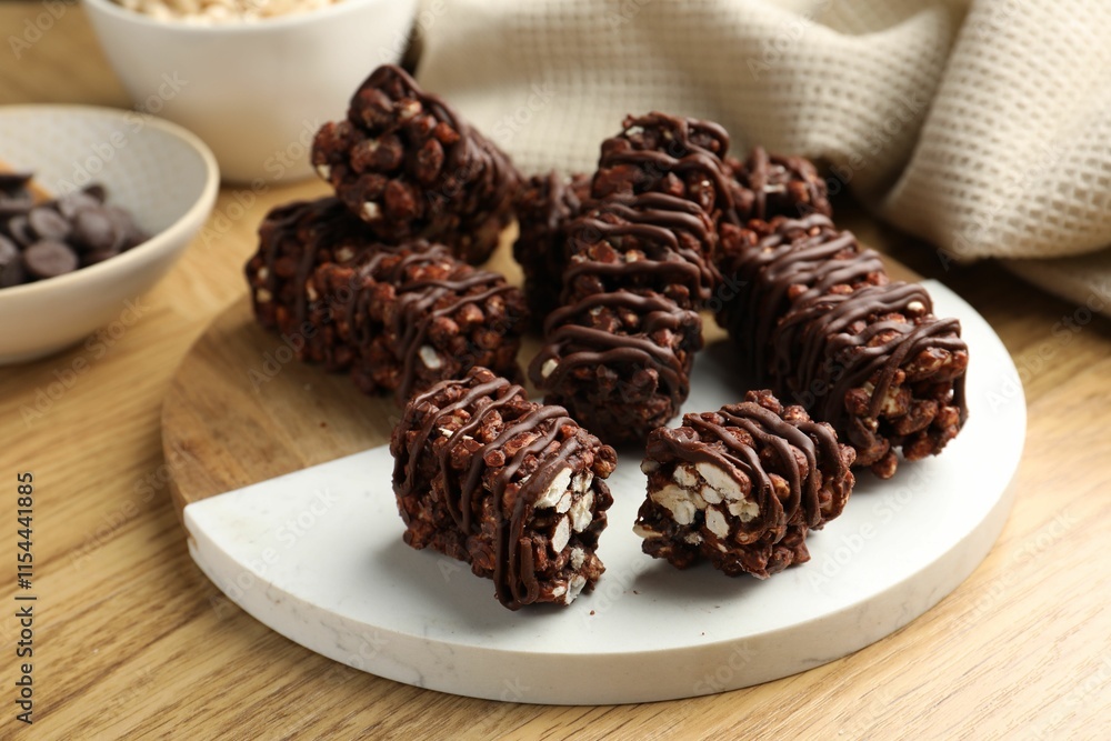 Delicious chocolate puffed rice bars on wooden table, closeup Delicious chocolate puffed rice bars on wooden table, closeup