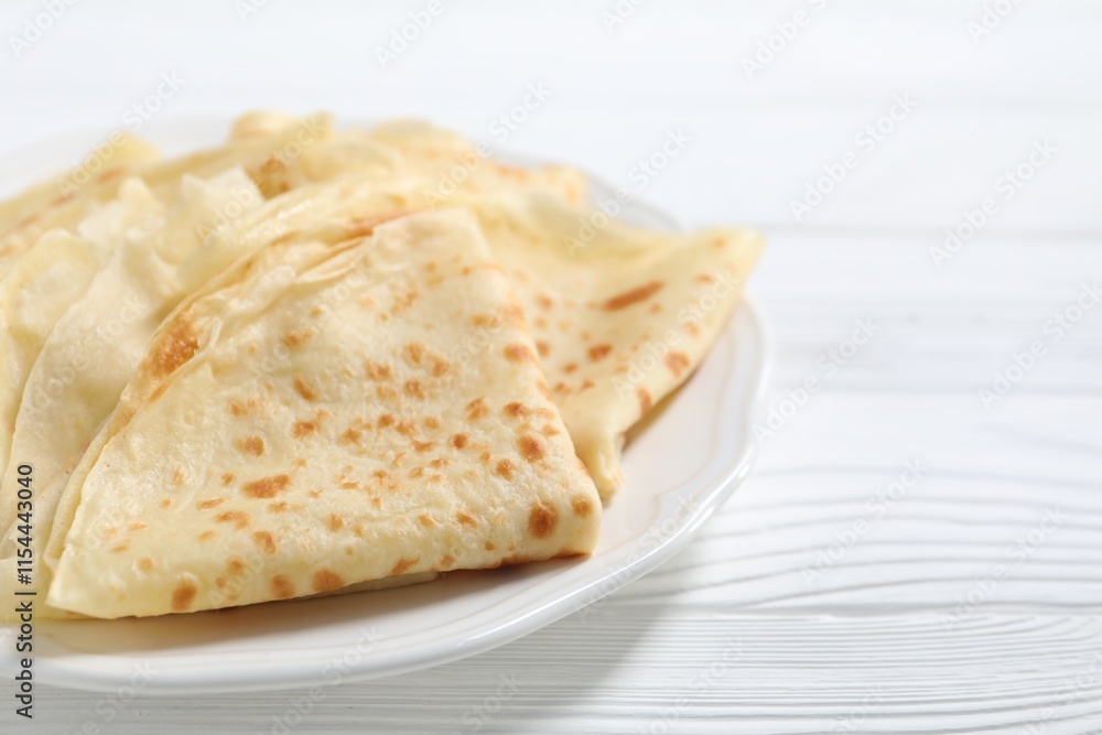 Tasty crepes on white wooden table, closeup. Space for text Tasty crepes on white wooden table, closeup. Space for text