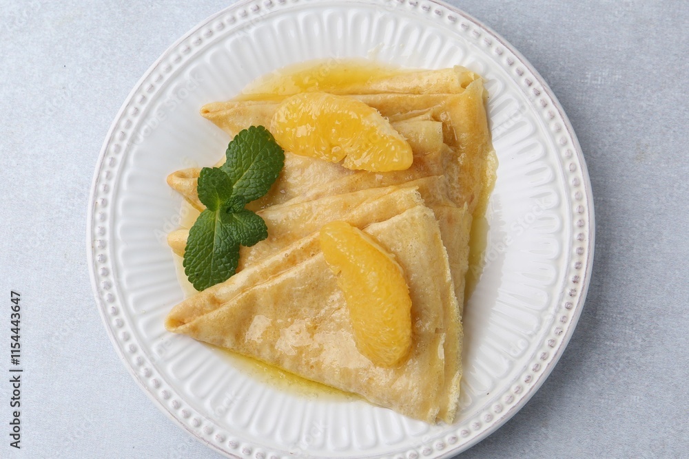 Delicious Crepes Suzette on light table, top view Delicious Crepes Suzette on light table, top view
