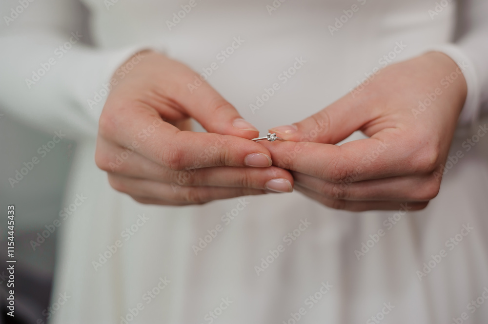 Elegant Bridal Hands Holding a Delicate Ring Elegant Bridal Hands Holding a Delicate Ring