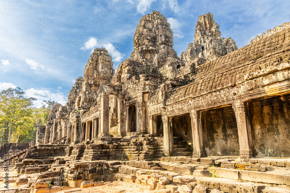 Ancient Bayon stone temple with carved stone faces, Angkor Thom, Siem Reap, Cambodia Ancient Bayon stone temple with carved stone faces, Angkor Thom, Siem Reap, Cambodia