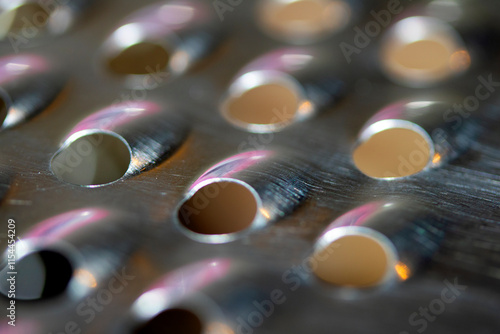 Close Up of a Steel Metal Perferated Hole Background Abstract Futeristic Circles photo