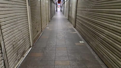 シャッターが閉まった通路を歩くスローモーション
