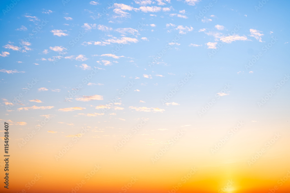 Obraz premium Beautiful , luxury soft gradient orange gold clouds and sunlight on the blue sky perfect for the background, take in everning,Twilight, Large size, high definition landscape photo