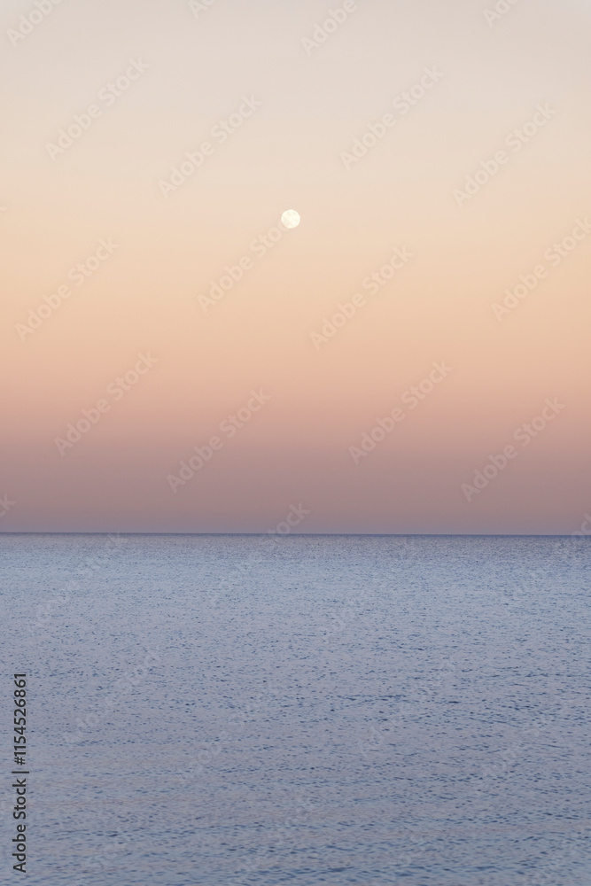 The view after sunset by the sea and the full moon in the sky The view after sunset by the sea and the full moon in the sky