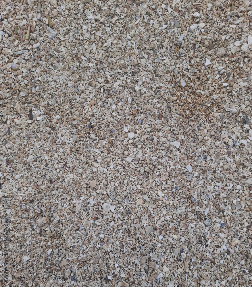 A rocky surface at the beach. A lot of different sizes and colors of small rocks, creating a visually beautiful textured background A rocky surface at the beach. A lot of different sizes and colors of small rocks, creating a visually beautiful textured background
