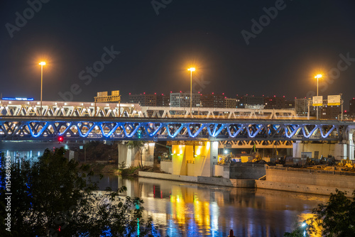 The scyscrapers of the Moscow City at night and the Dorogomilovsky bridge with illumination. Translation of text - street names: Krasnopresnenskaya, center, etc. photo