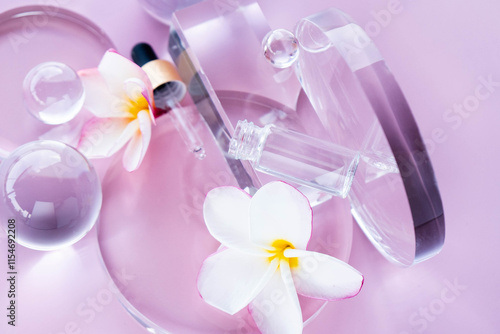 Display includes serum with aloe and centella, surrounded by glass elements and flower petals. Flat lay.