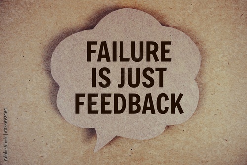 Failure Is Just Feedback text with speech bubble on paper craft background photo