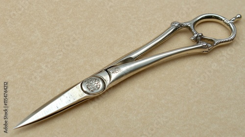 Antique silver-plated scissors with ornate handles and pointed blades. photo