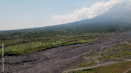 4K Drone Video of Semaru Volcano, surrounded by green forest landscapes and molton rock after a volcano eruption in East Java Indonesia photo