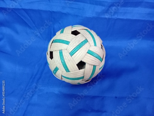 sepaktakraw or takraw or  buka ball, kick volleyball or foot volleyballball on blue background, closeup of photo taken in malaysia. photo