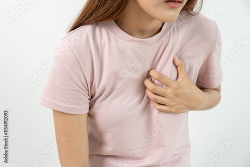 hand hold chest with heart attack symptoms, asian woman working hard have chest pain caused by heart disease, leak, dilatation, enlarged coronary heart, press on the chest with painful expression photo