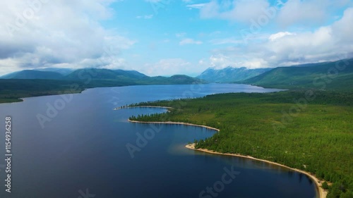  Aerial view of tranquil lake surrounded by forest and mountains