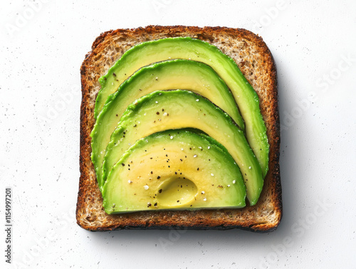 Avocado slices on whole grain toast with seasoning photo