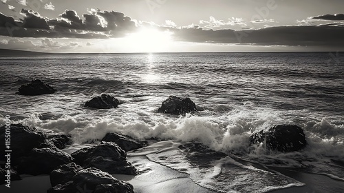 Black and white sunset over the ocean. Dramatic seascape with waves crashing on rocks.