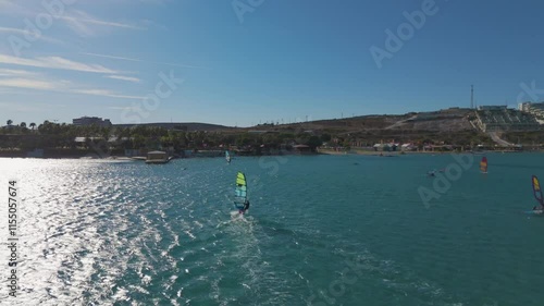 Surfers sailing on a sailboat drone footage