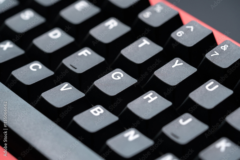Extreme close up of black mechanical keyboard keycaps with white lettering, captured from a top-side angle for a detailed and modern aesthetic. Extreme close up of black mechanical keyboard keycaps with white lettering, captured from a top-side angle for a detailed and modern aesthetic.
