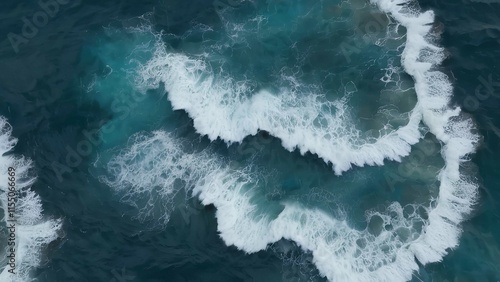 the ocean is blue and green with white waves crashing on rocks and shore rocks at the end