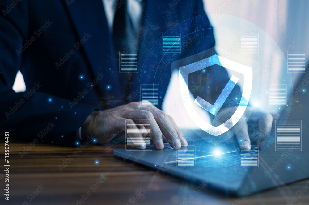 Man working on a laptop with advanced cyber security shield, ensuring the protection of sensitive data and securing the digital environment against potential threats.