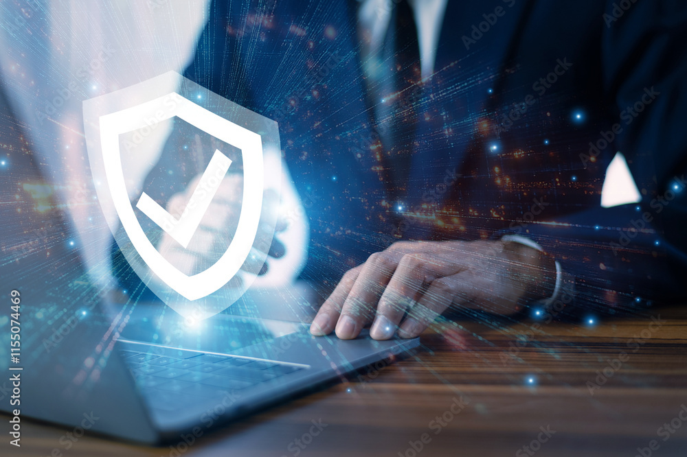 Man working on a laptop with advanced cyber security shield, ensuring the protection of sensitive data and securing the digital environment against potential threats.