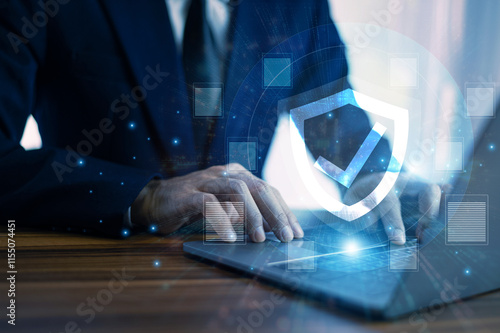 Obraz na płótnie Man working on a laptop with advanced cyber security shield, ensuring the protection of sensitive data and securing the digital environment against potential threats. w salonie
