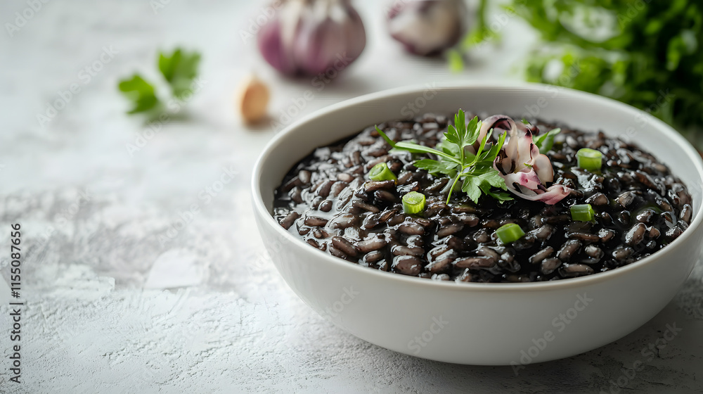 Black Risotto with Cuttlefish and Fresh Herbs in Bowl Black Risotto with Cuttlefish and Fresh Herbs in Bowl