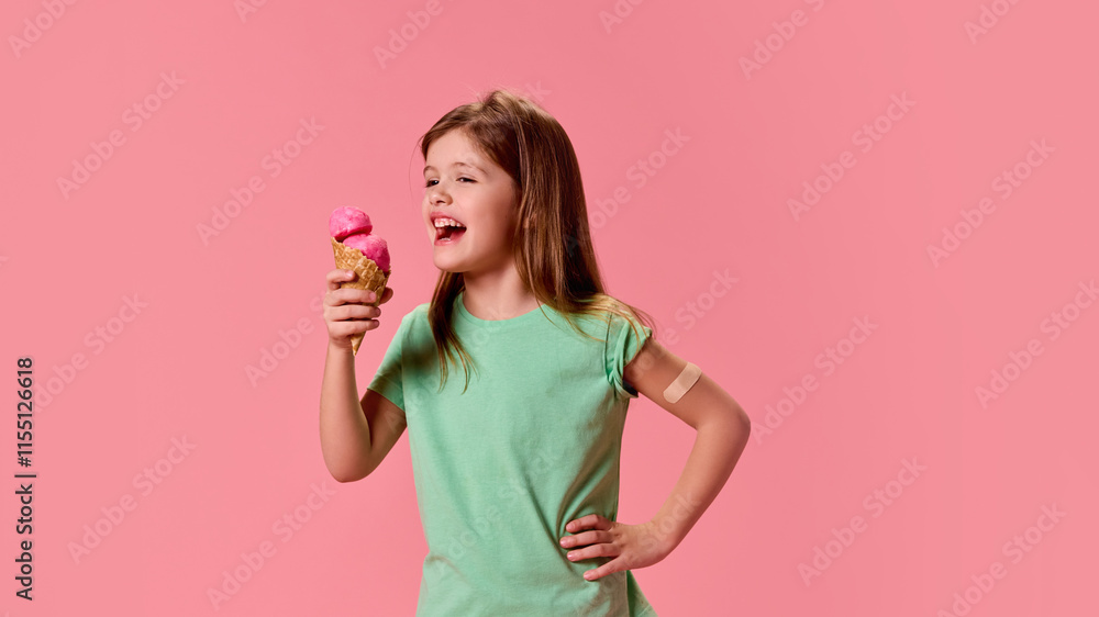 Laughing girl in green shirt, enjoying ice cream cone, radiating happiness, after vaccination against pink studio background. Concept of healthcare, protection, immunity, prevention. Laughing girl in green shirt, enjoying ice cream cone, radiating happiness, after vaccination against pink studio background. Concept of healthcare, protection, immunity, prevention.