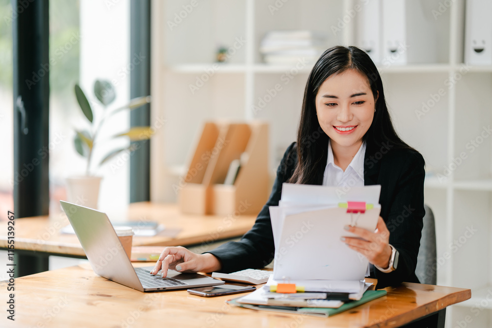 Asian business woman Working at the office with documents on the table Planning to analyze financial reports business plan investment financial analysis concepts Asian business woman Working at the office with documents on the table Planning to analyze financial reports business plan investment financial analysis concepts