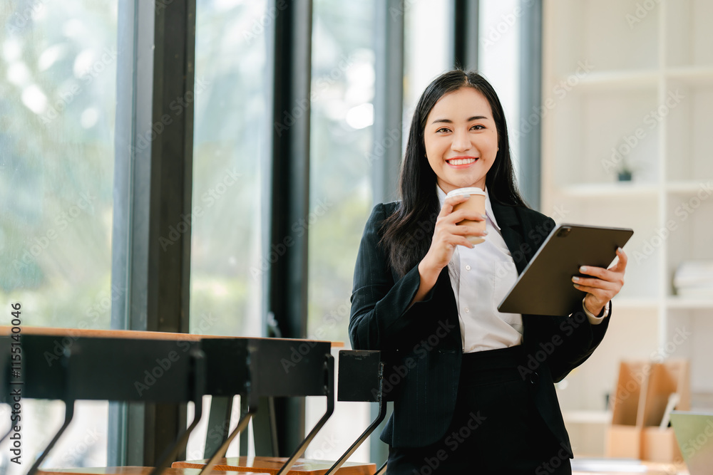 Fototapeta premium Smiling businesswoman holding phone in modern office