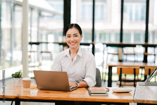Asian female student studying online and taking notes. Female accountant doing annual financial and tax reports