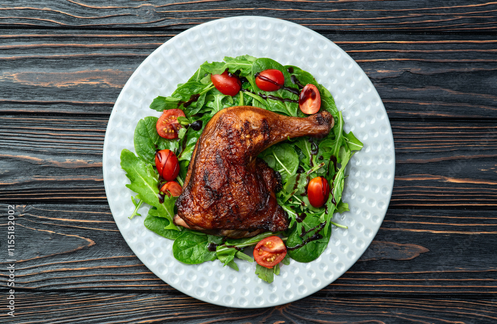 Grilled chicken legs with tomatoes and salad . Top view Grilled chicken legs with tomatoes and salad . Top view