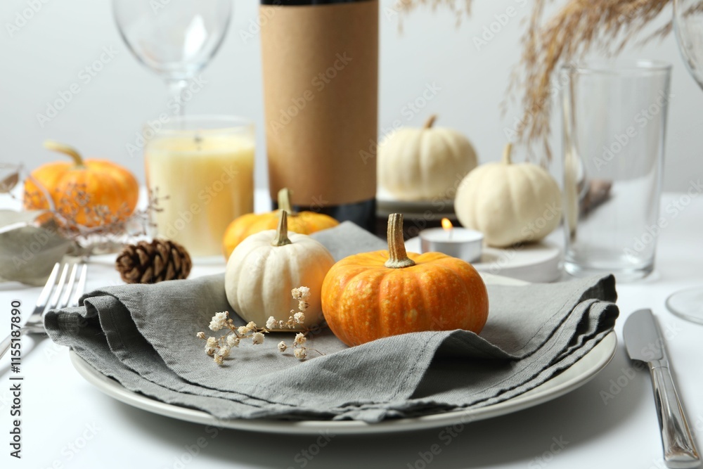 Rustic holiday table setup with plates, cutlery and autumn decorations Rustic holiday table setup with plates, cutlery and autumn decorations