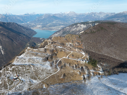 Monte Pizzoc panoramica aerea dall'alto sulle dolomiti  durante giornata di sole e cielo terso con vista sul Lago  di Santa Croce photo